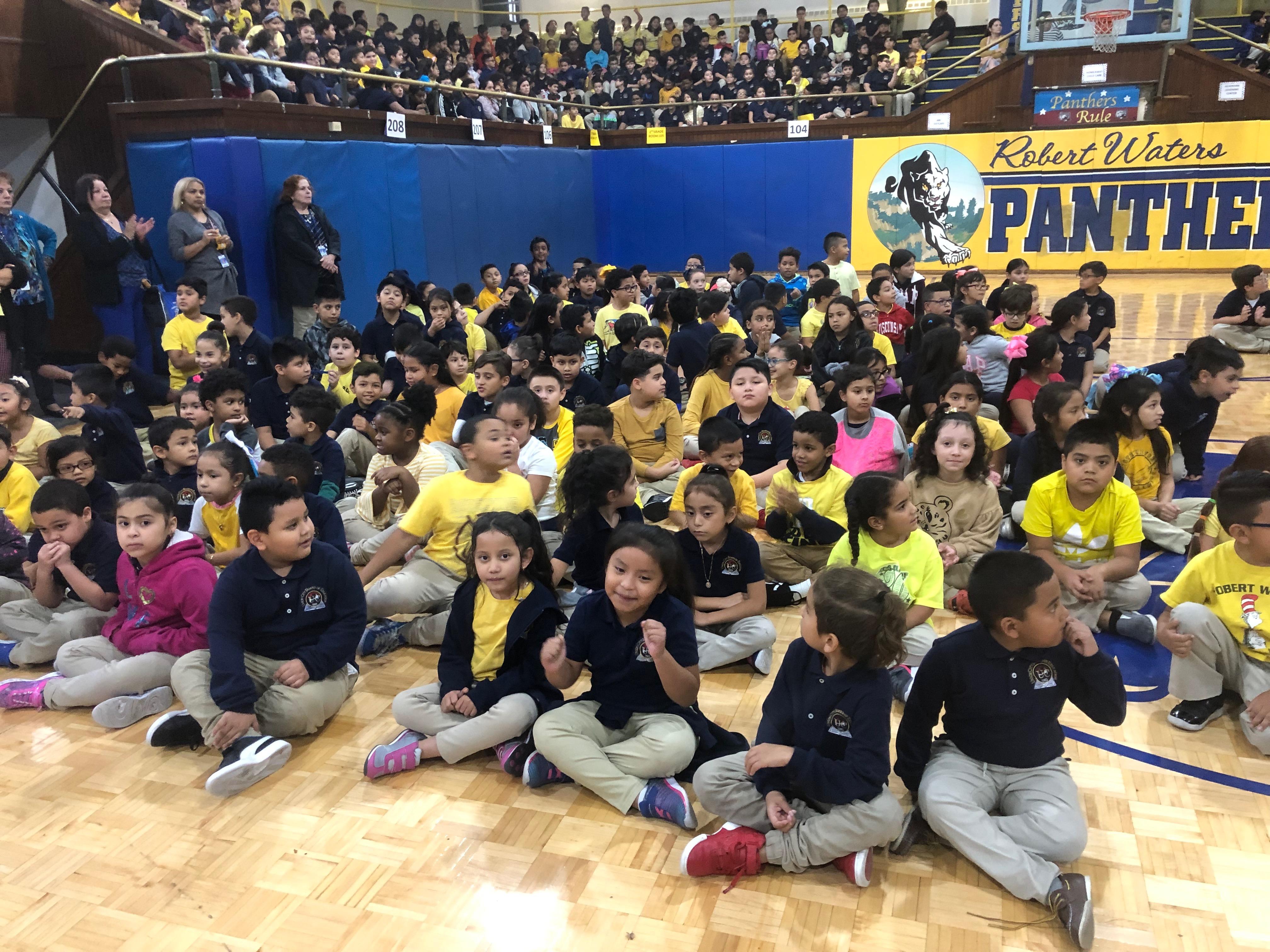 kids seated and waiting for the assembly