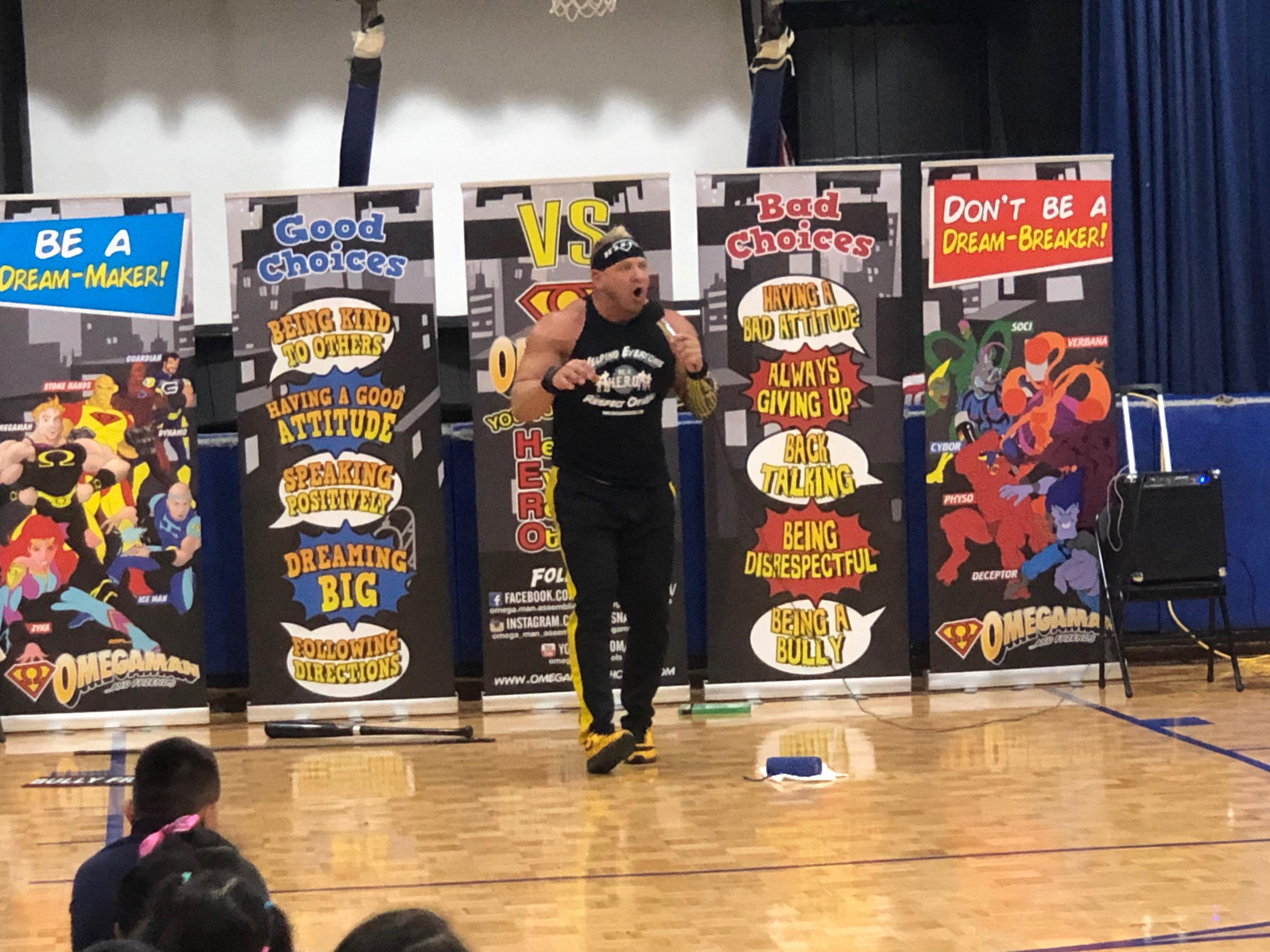 Omegaman talking to students about bullying