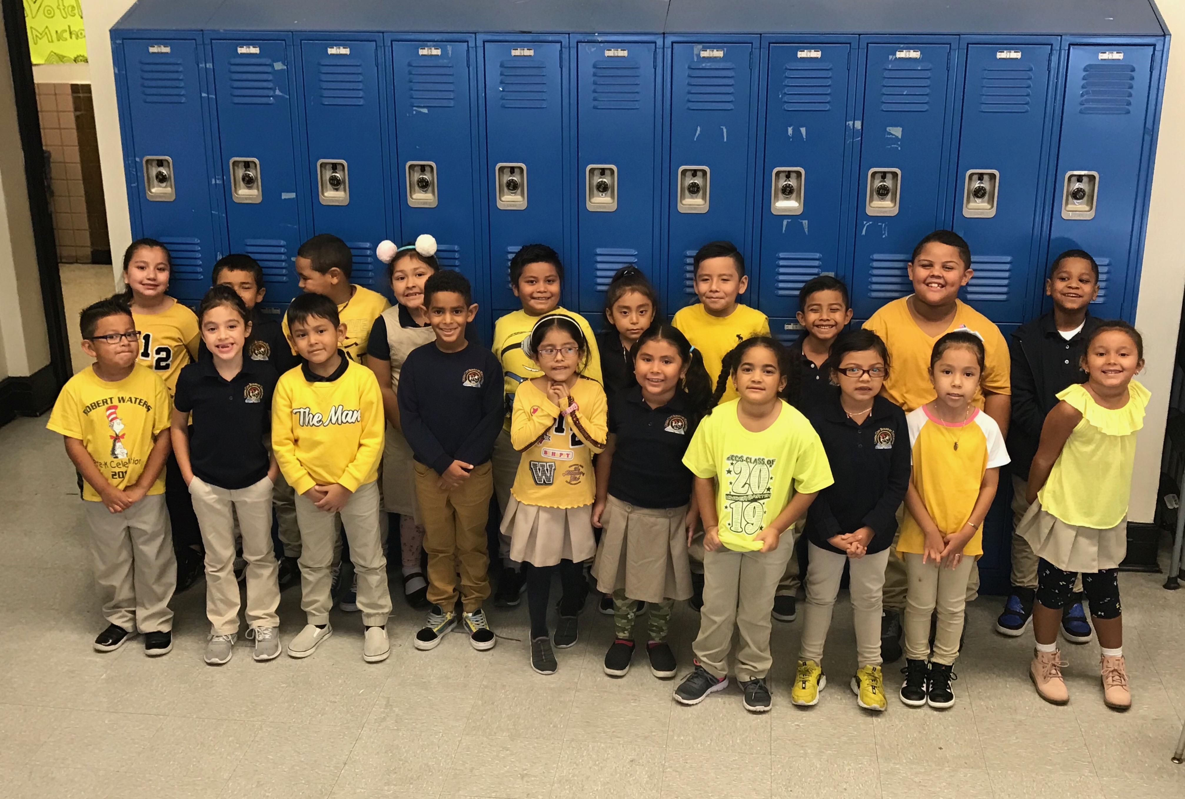 a class of children wearing yellow t-shirts to support the golden rule