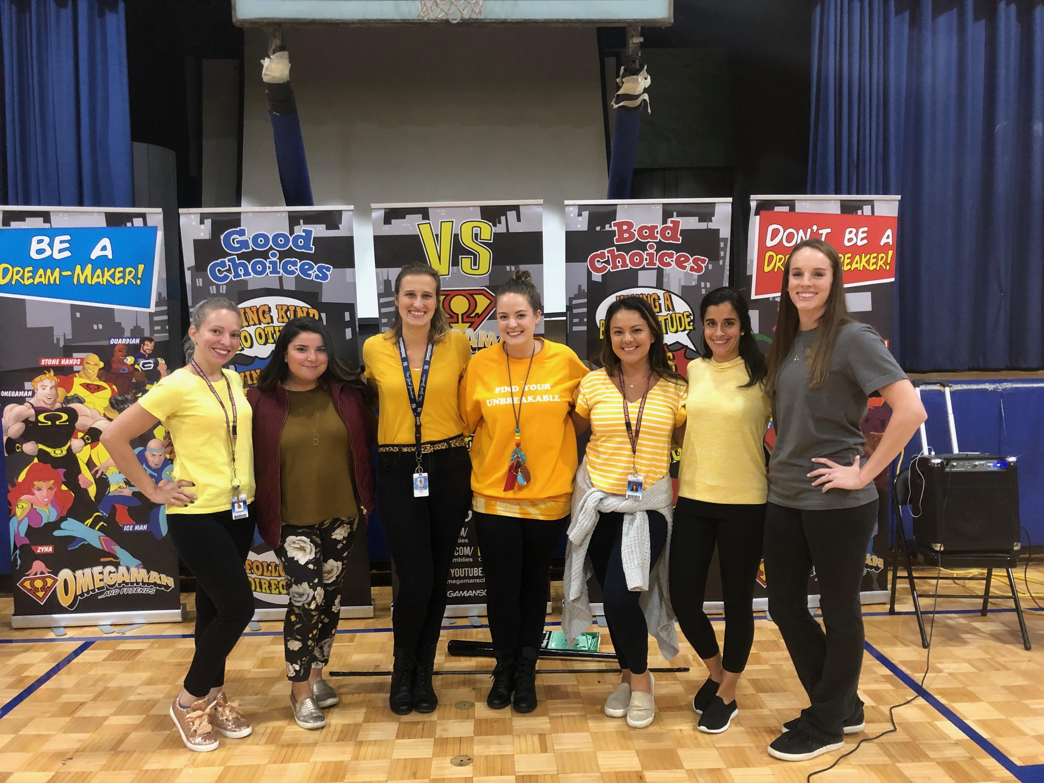 teachers showing off their yellow t-shirts